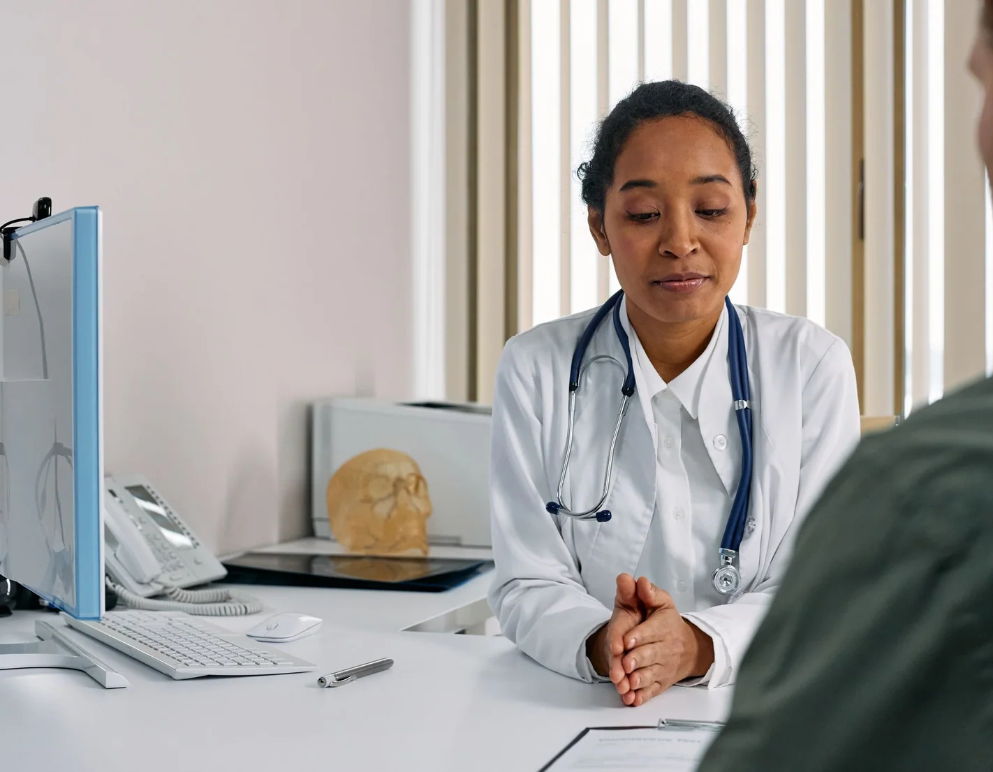 A doctor going through a cholesterol result with a patient at Aton Clinic