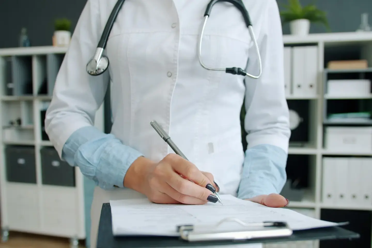 A doctor writing up a patient's results at Aton Clinic